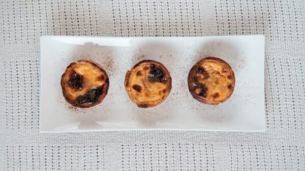 Three Egg Tarts on a Rectangular White Tray